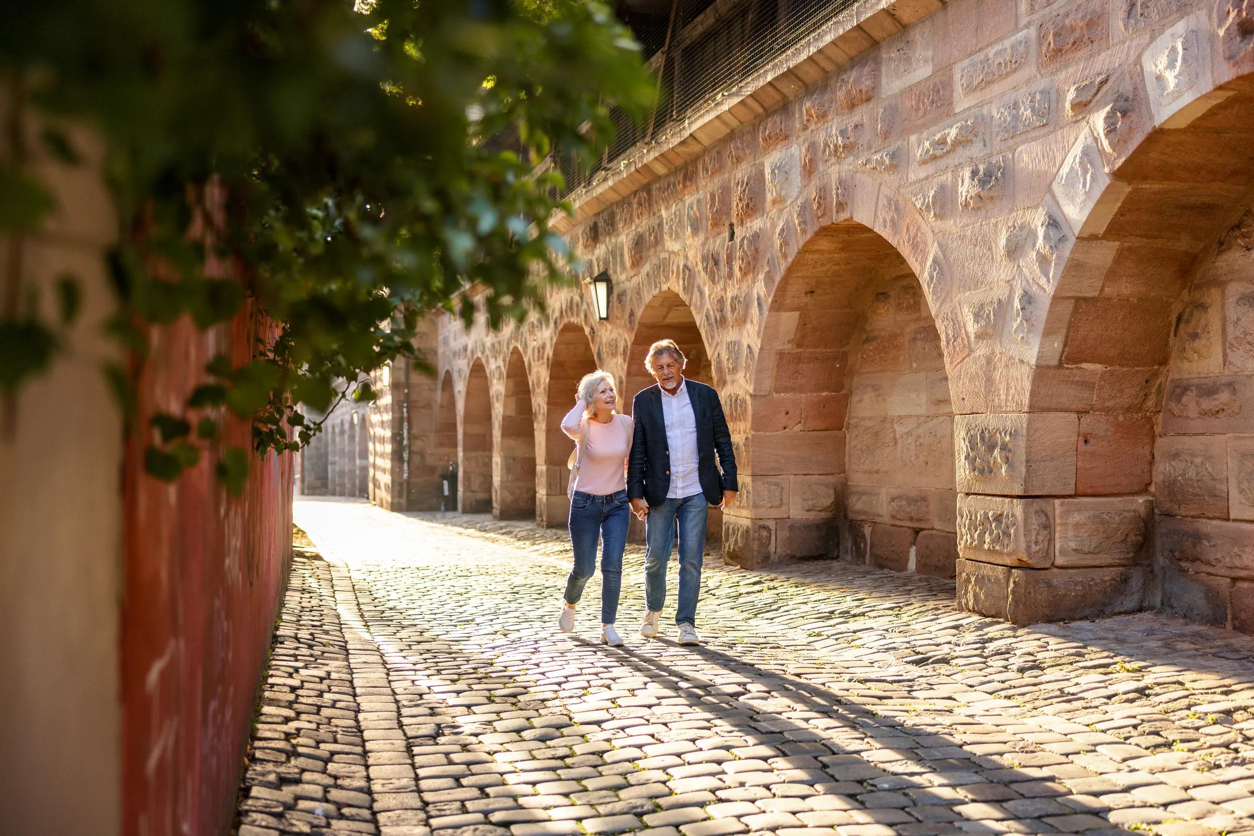 Senior Couple Exploring German Town In Summer