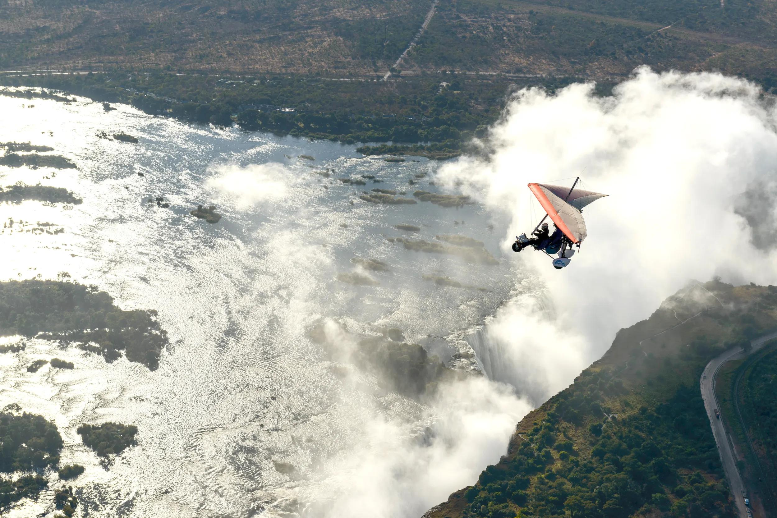 Aerial view of a micorlight (ultralight) flying over the Zambezi River and Victoria Falls. Livingstone. Zambia