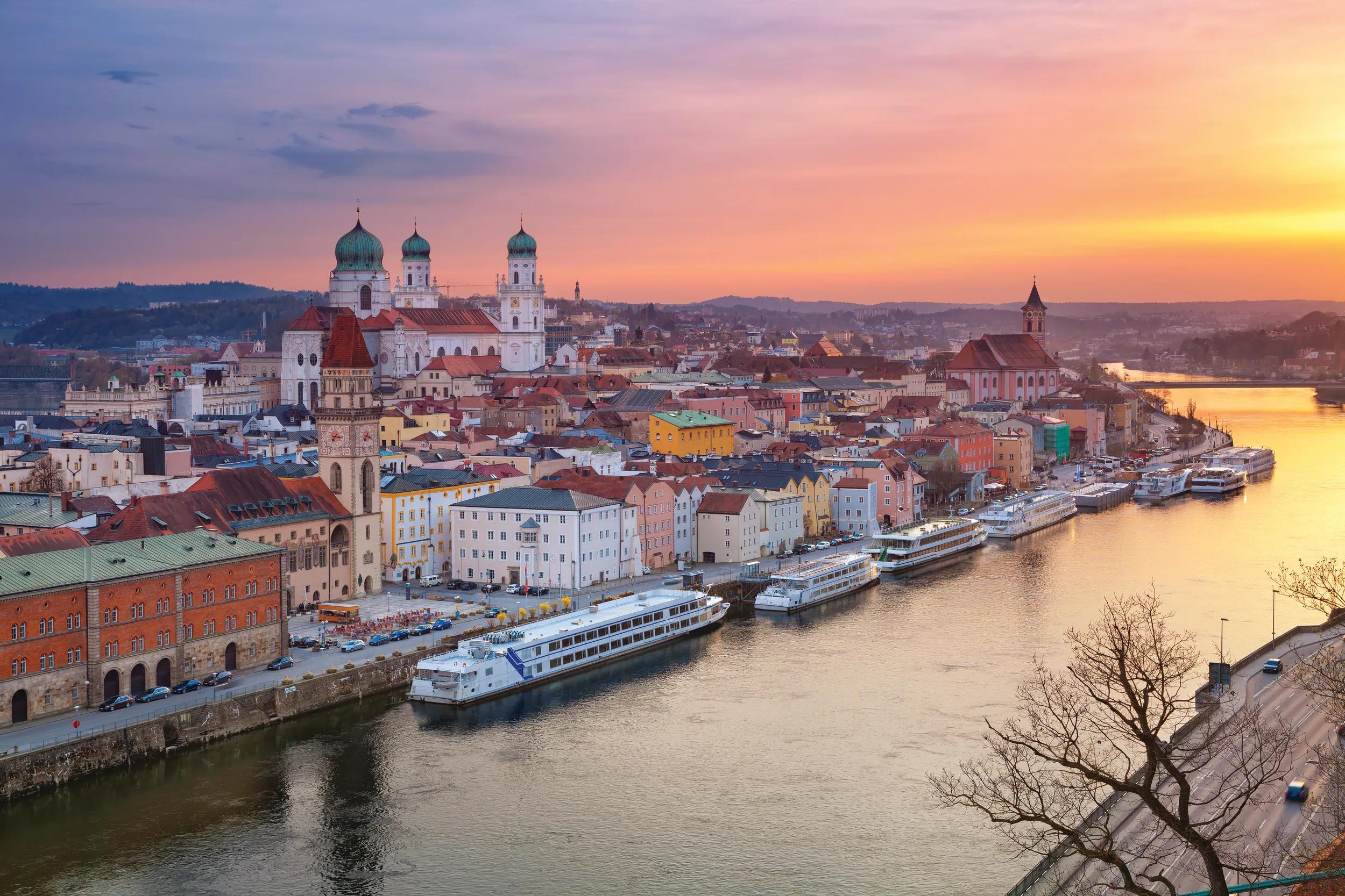 Passau skyline during sunset, Bavaria, Germany. The towers of St Stephen's Cathedral behind the clock tower of the Old Town Hall.