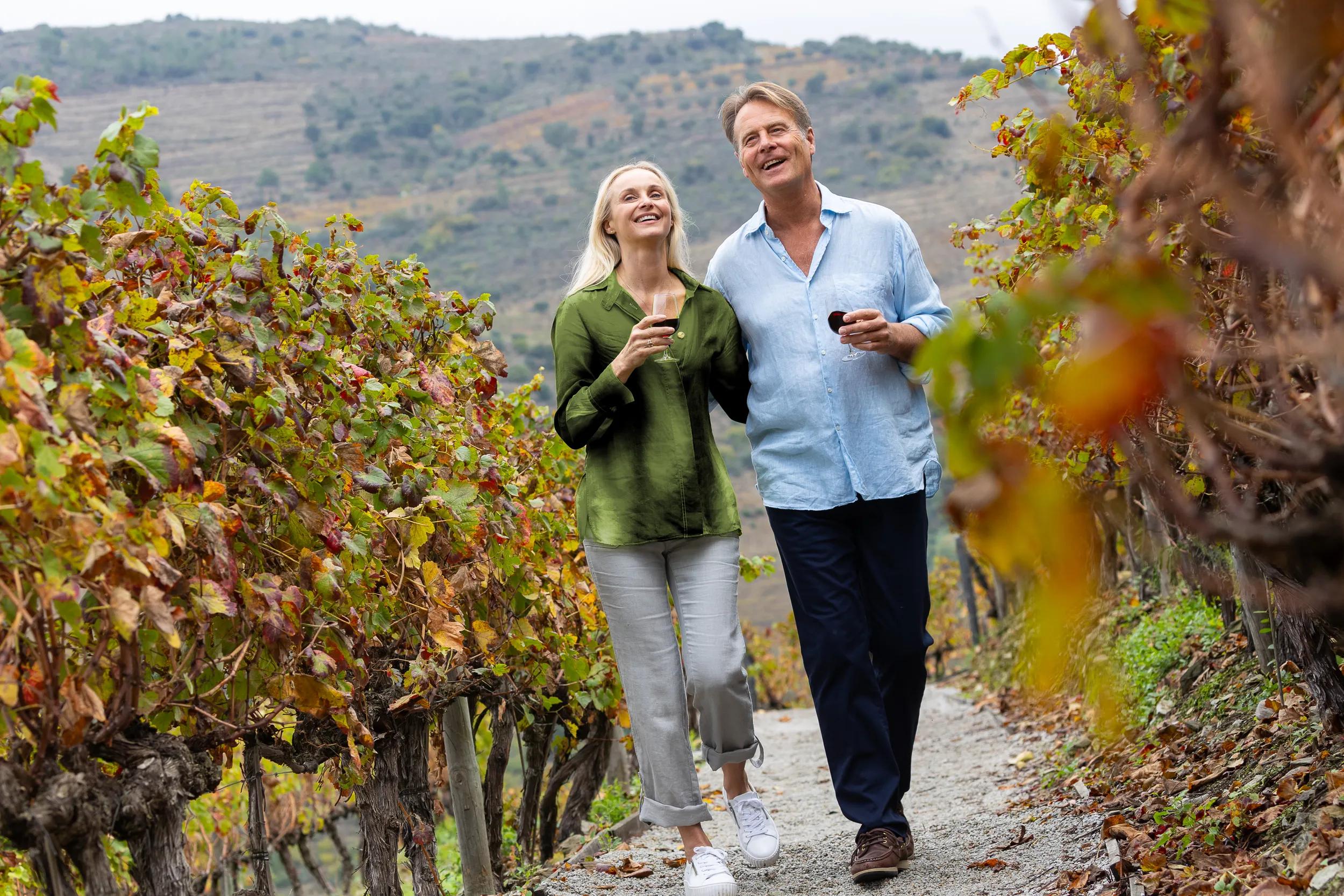 APT couple walking through vineyard with glasses of wine - Douro Estrela photoshoot 2024