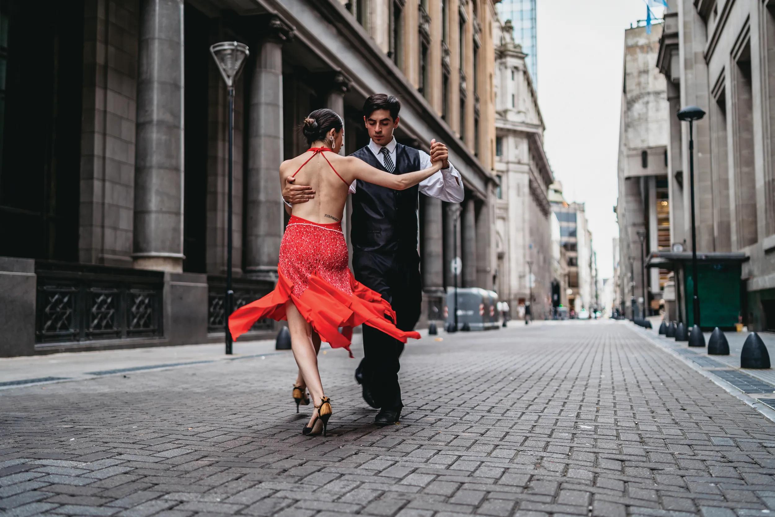 Young Latin couple dancing tango on city street. Buenos Aires, Argentina.