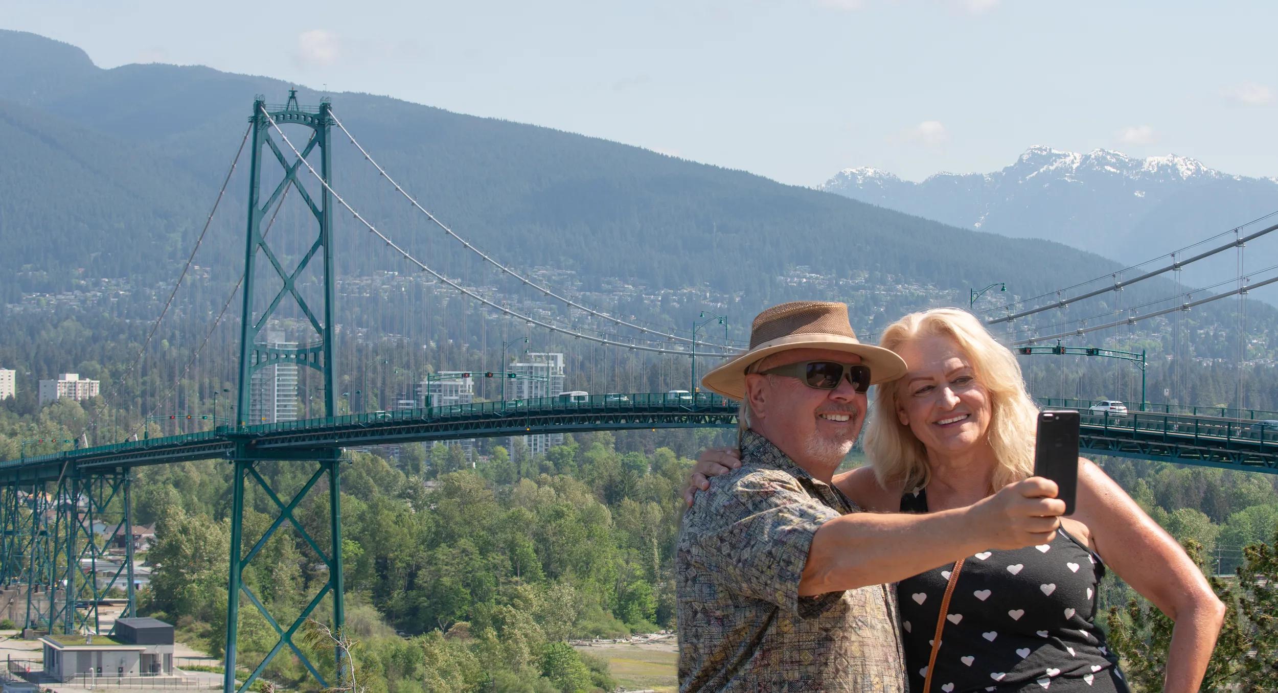 A mature man takes a selfie of himself and his wife while travelling in Vancouver, Canada