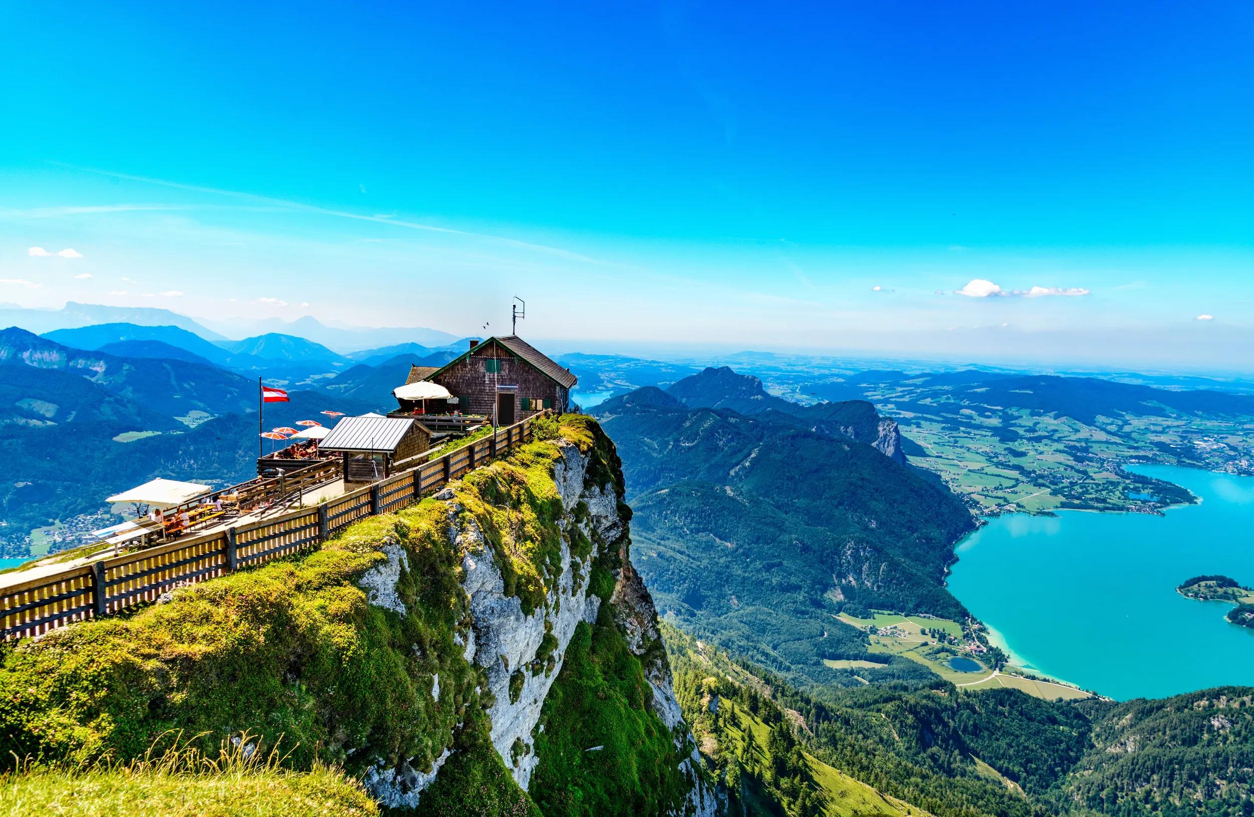 Amazing panorama view from Schafberg by Sankt Wolfgang im Salzkammergut on Haus house Schafbergspitze, lake Mondsee (moonlake, moon), Attersee. Blue sky, alps mountains. Upper Austria, Salzburg