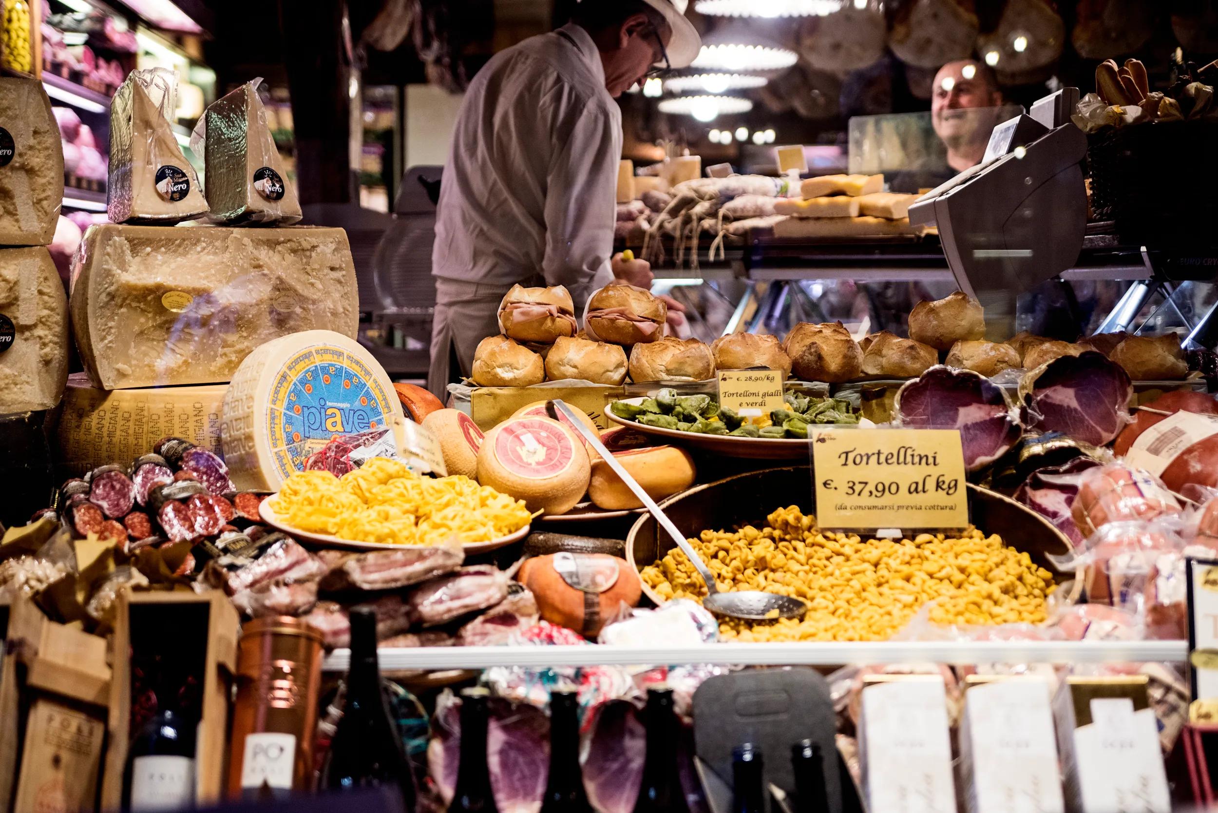 Typical view of a pasta store the city of Bologna, Italy. Salesman and client in the background. Horizontal outdoors shot.