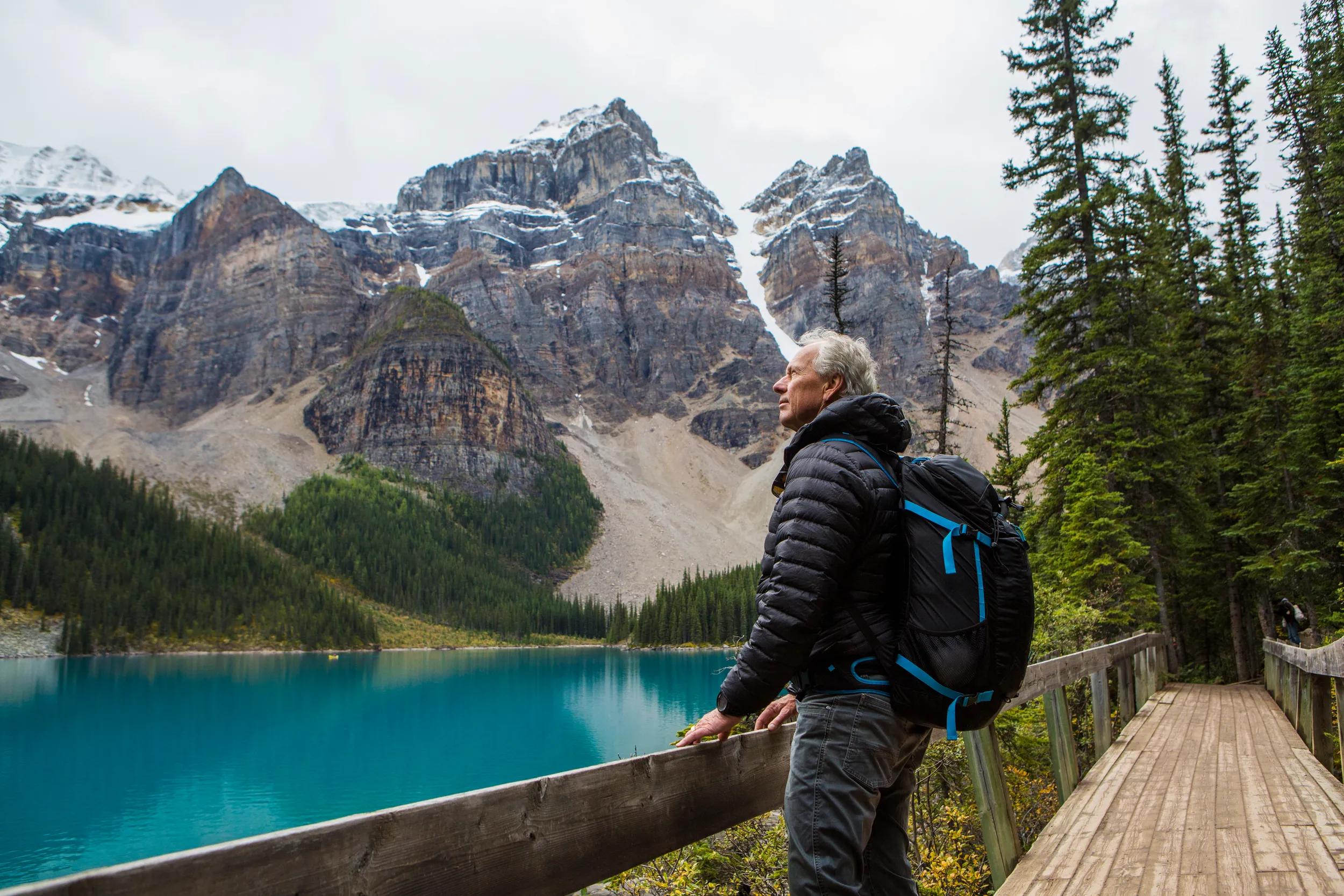 Caucasian man standing on boardwalk admiring mountain