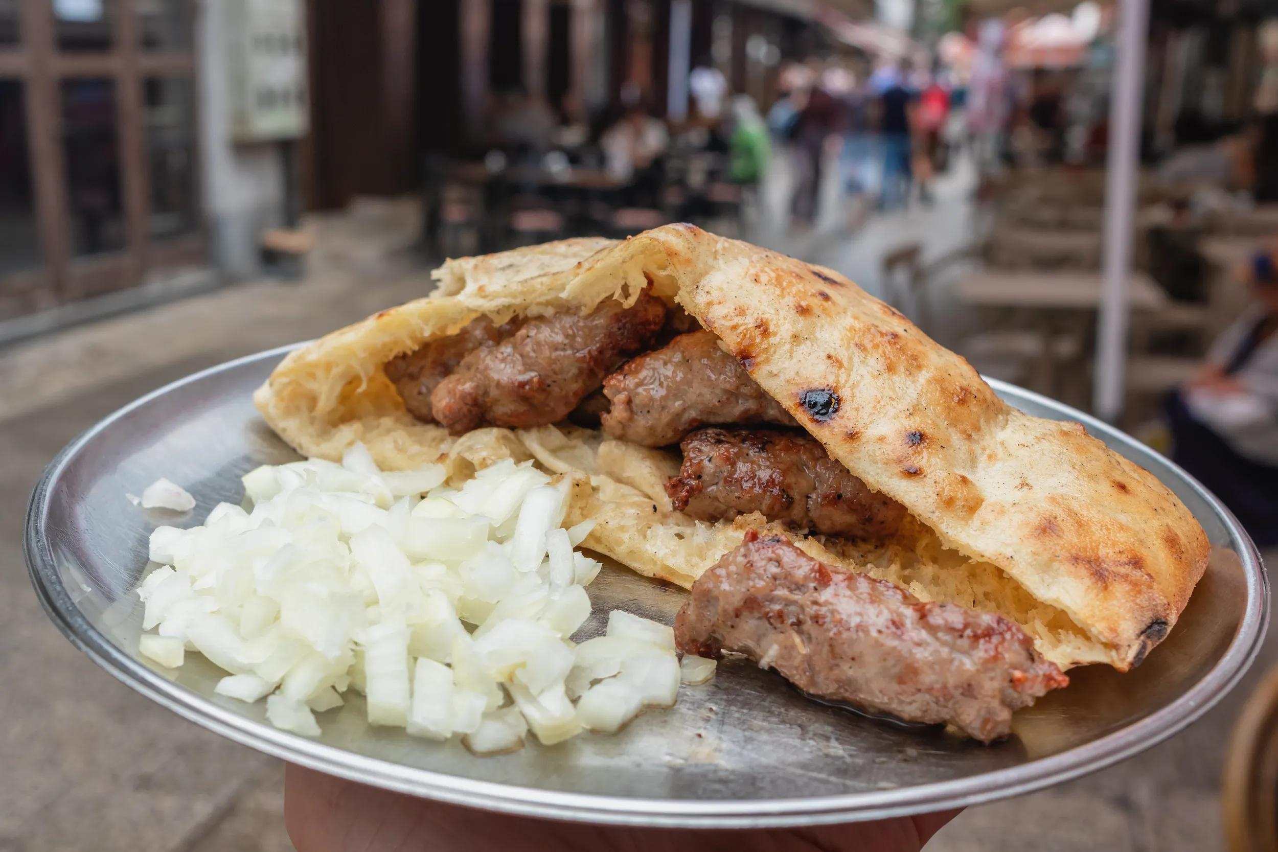 Traditional bosnian cevapi in Sarajevo, Bosnia and Herzegovina. Grilled dish of minced meat called cevapcici in buns