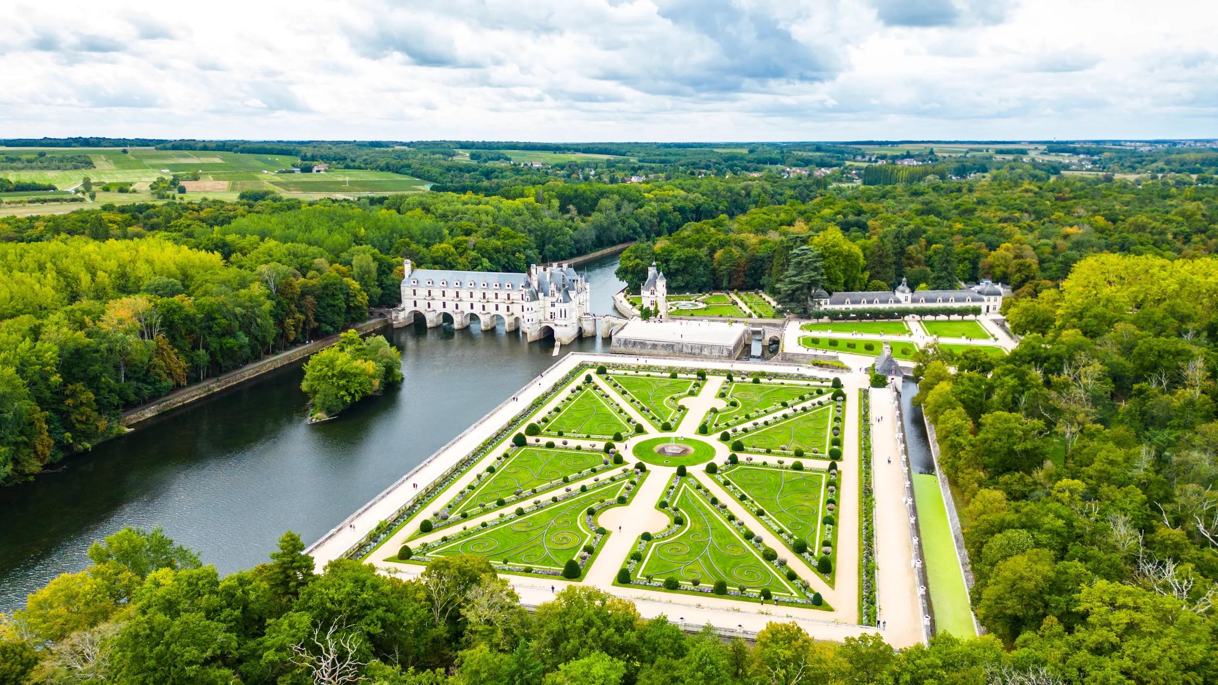 Aerial view of Château de Chenonceau, one of the most famous Loire Valley castles in France. Renaissance architecture spanning the River Cher, surrounded by lush forests and beautifully landscape