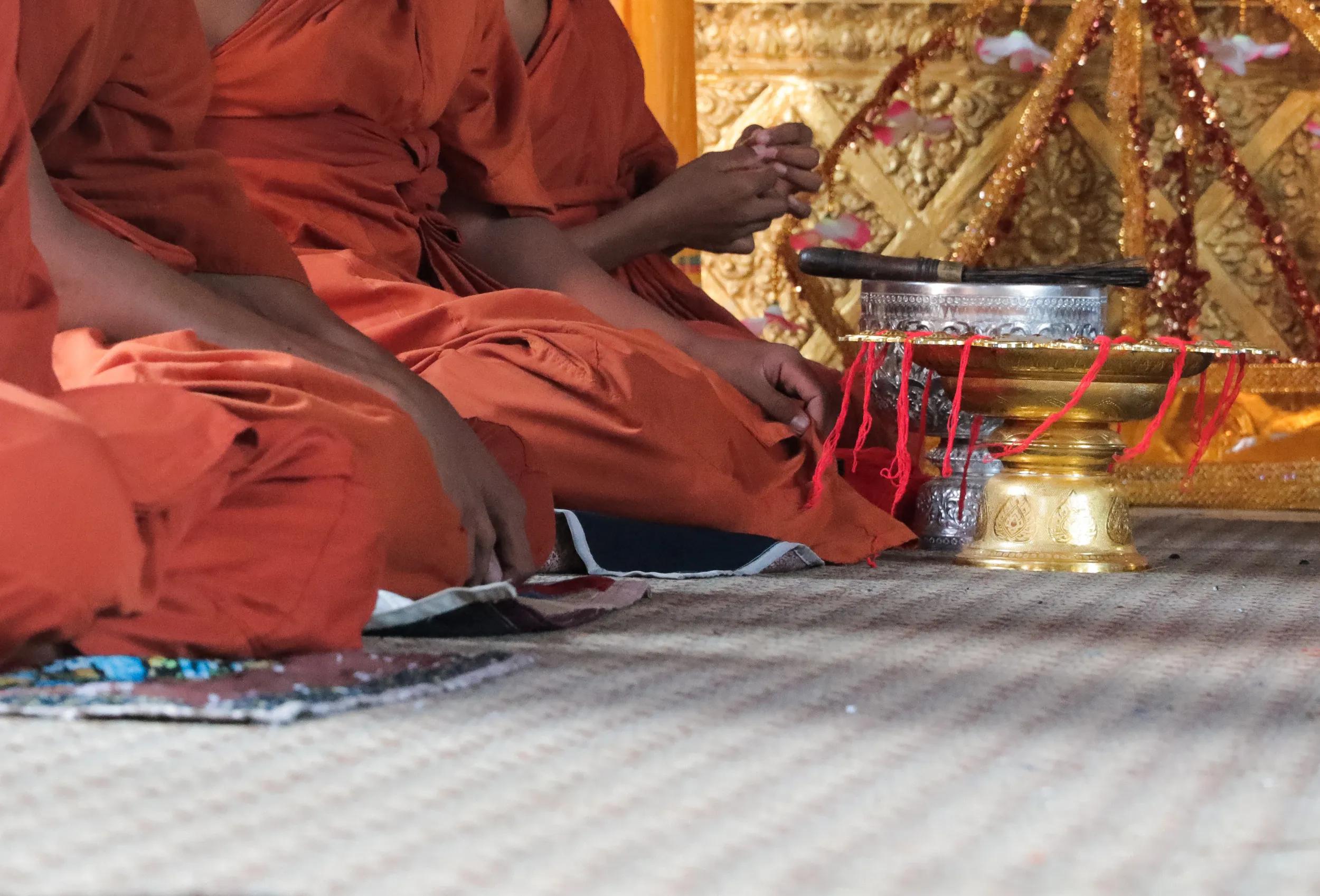 Young Buddhist Monks sitting and preparing blessing