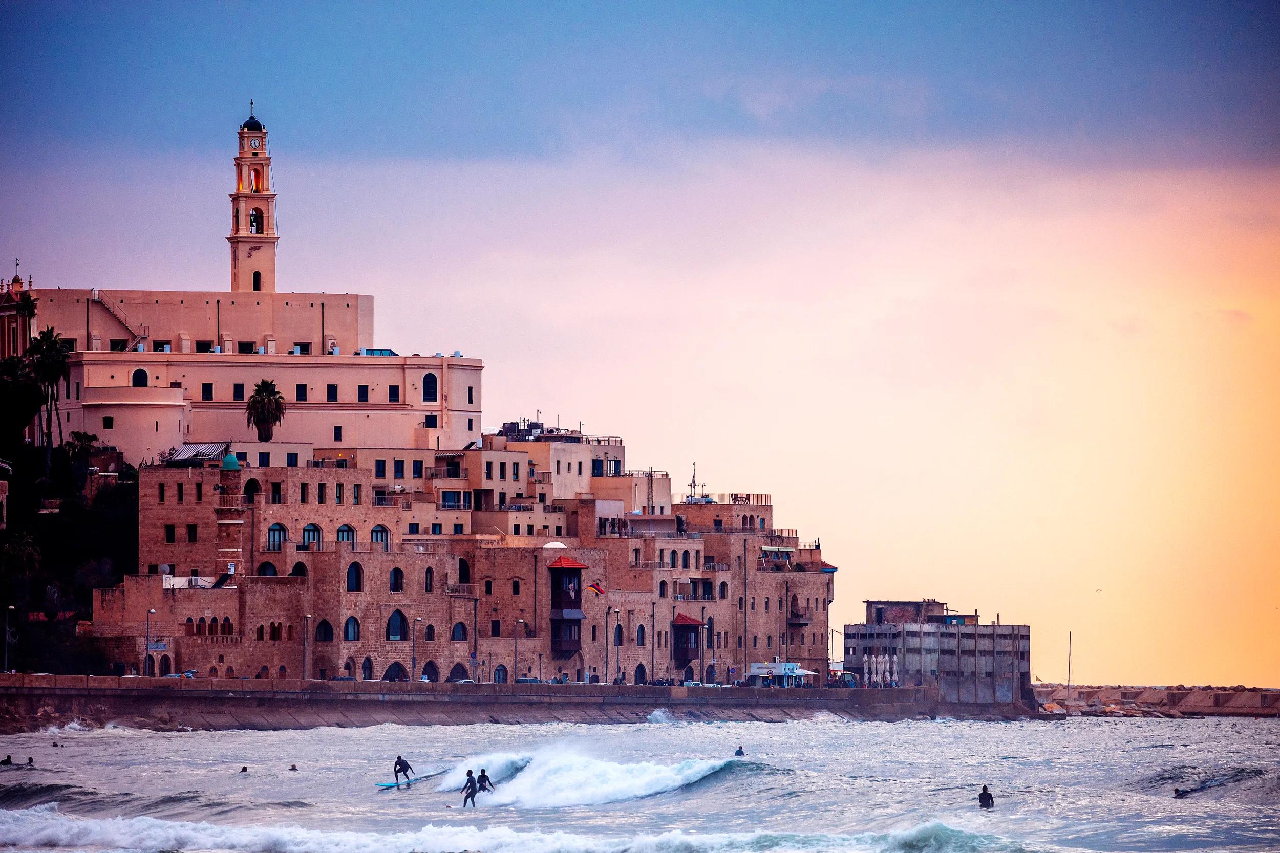 Jaffa sunset, surfers in action..Tel Aviv, Israel