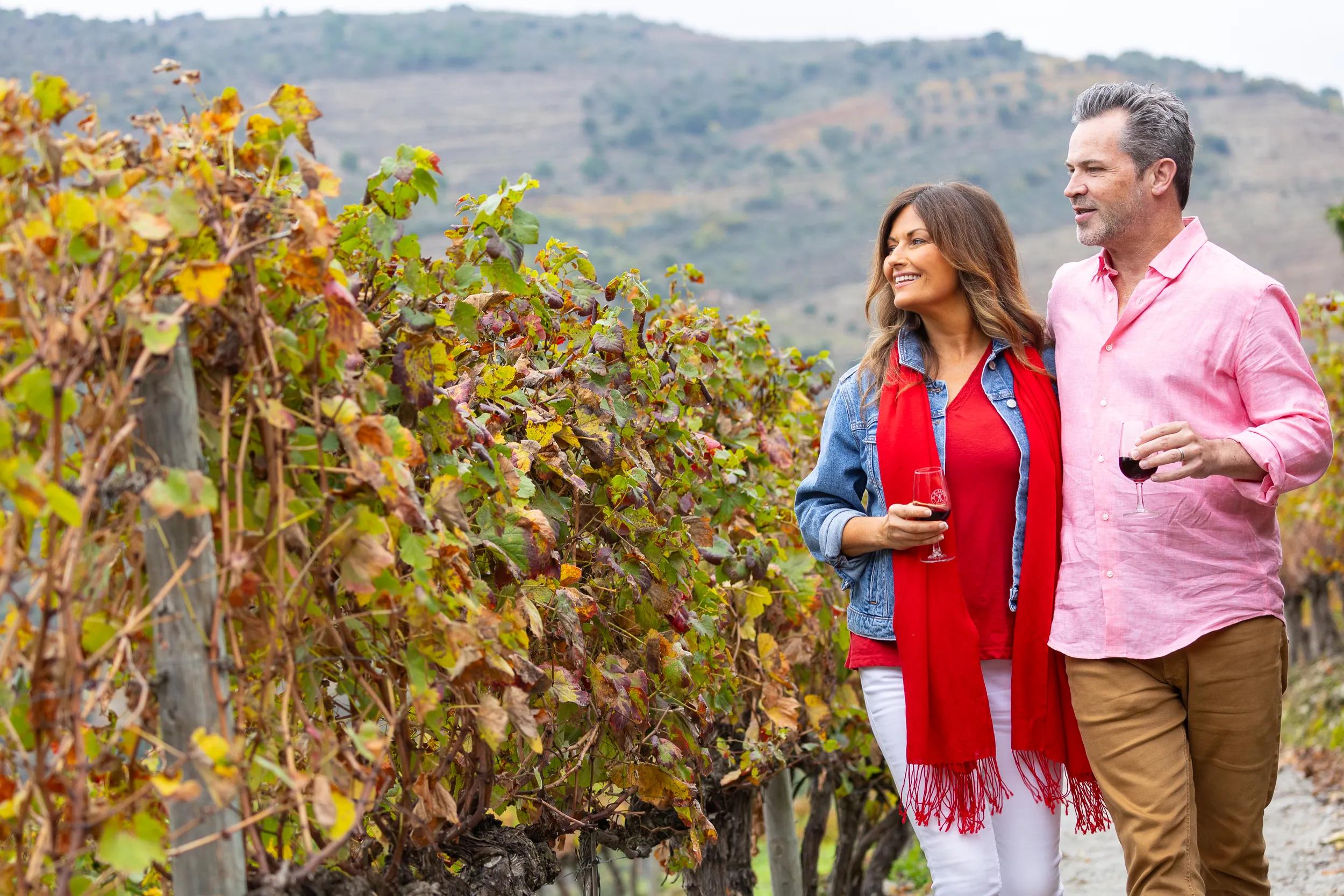 TM couple enjoying a wine walking through a vineyard - Douro Estrela photoshoot 2024