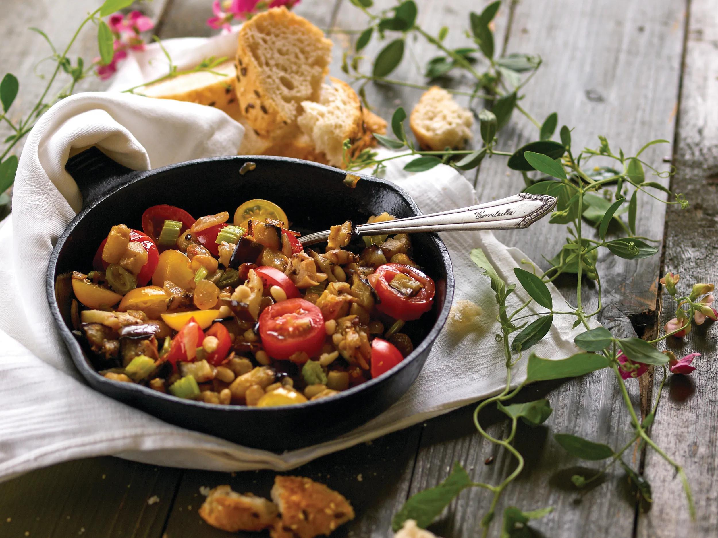 Caponata is a Sicilian eggplant cooked vegetable salad dish - chopped fried eggplant and celery seasoned with sweetened vinegar, with capers in a sweet and sour sauce.