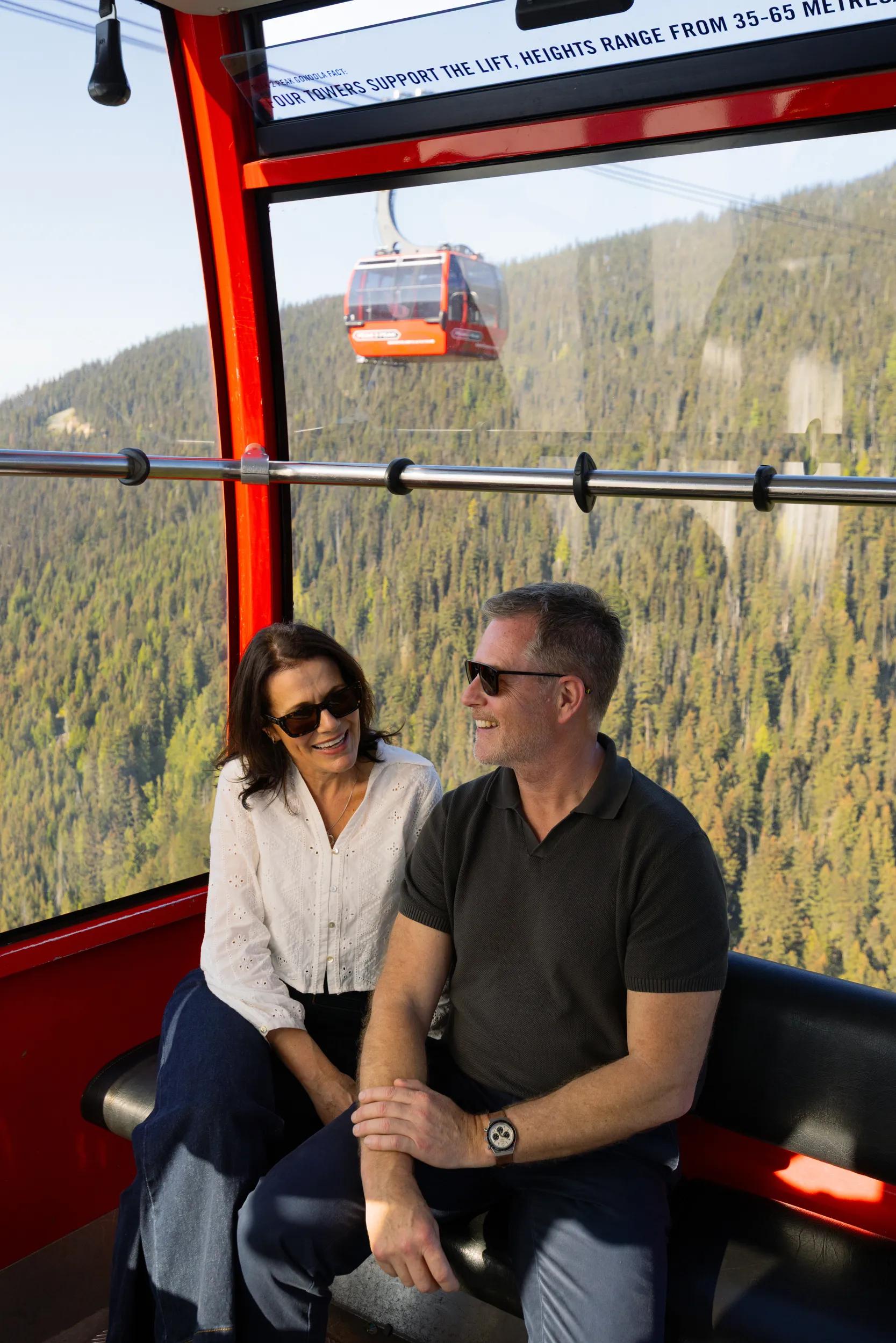 Couple on the Peak-2-Peak-Gondola connecting Whistler and Blackomb mountains, Whistler, BC, Canada.