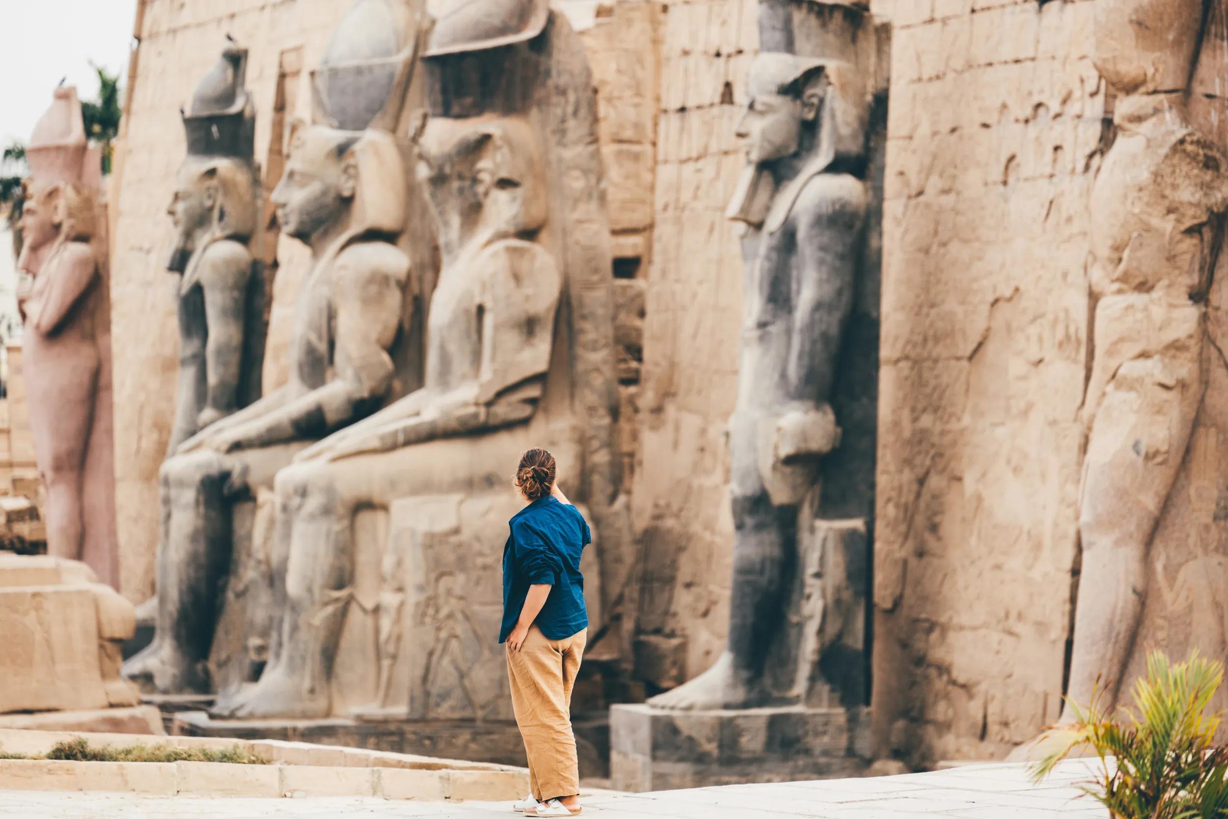 A woman explores the ancient temples of Luxor in Egypt.