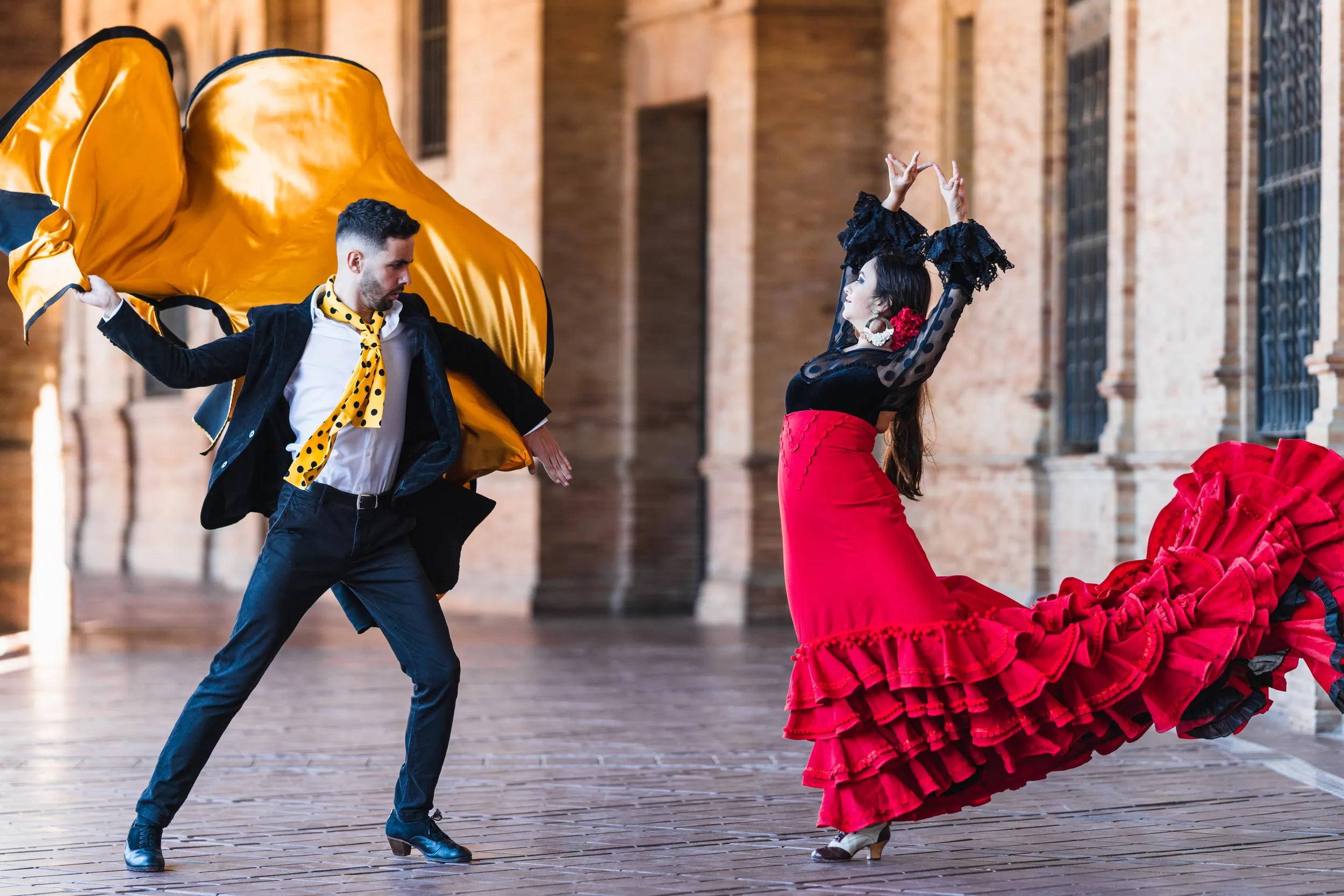 Man with a cloth dancing falmenco with a woman in the Spain square in Seville