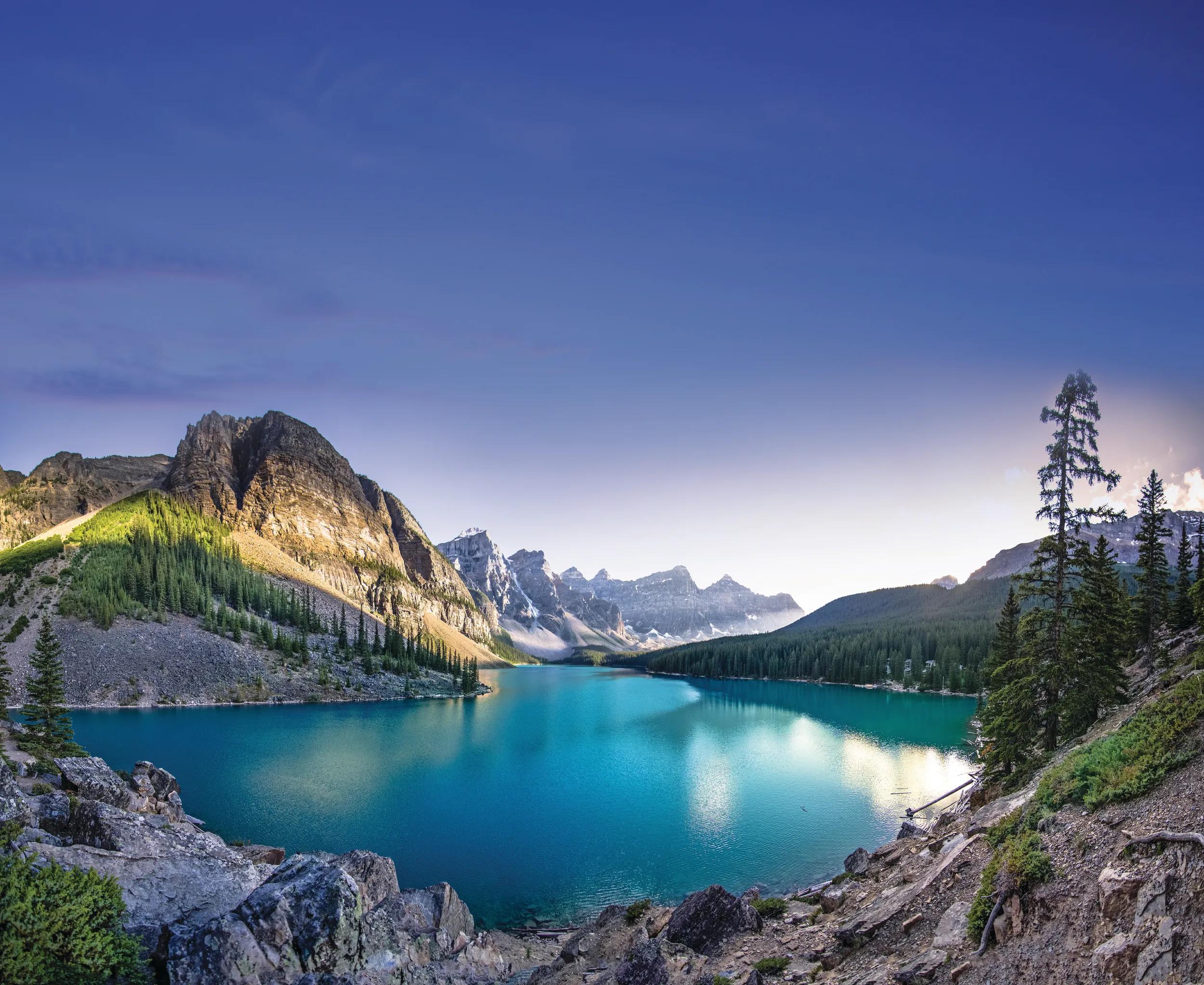 The emerald waters of Moraine Lake at sunset.  A panoramic photo.