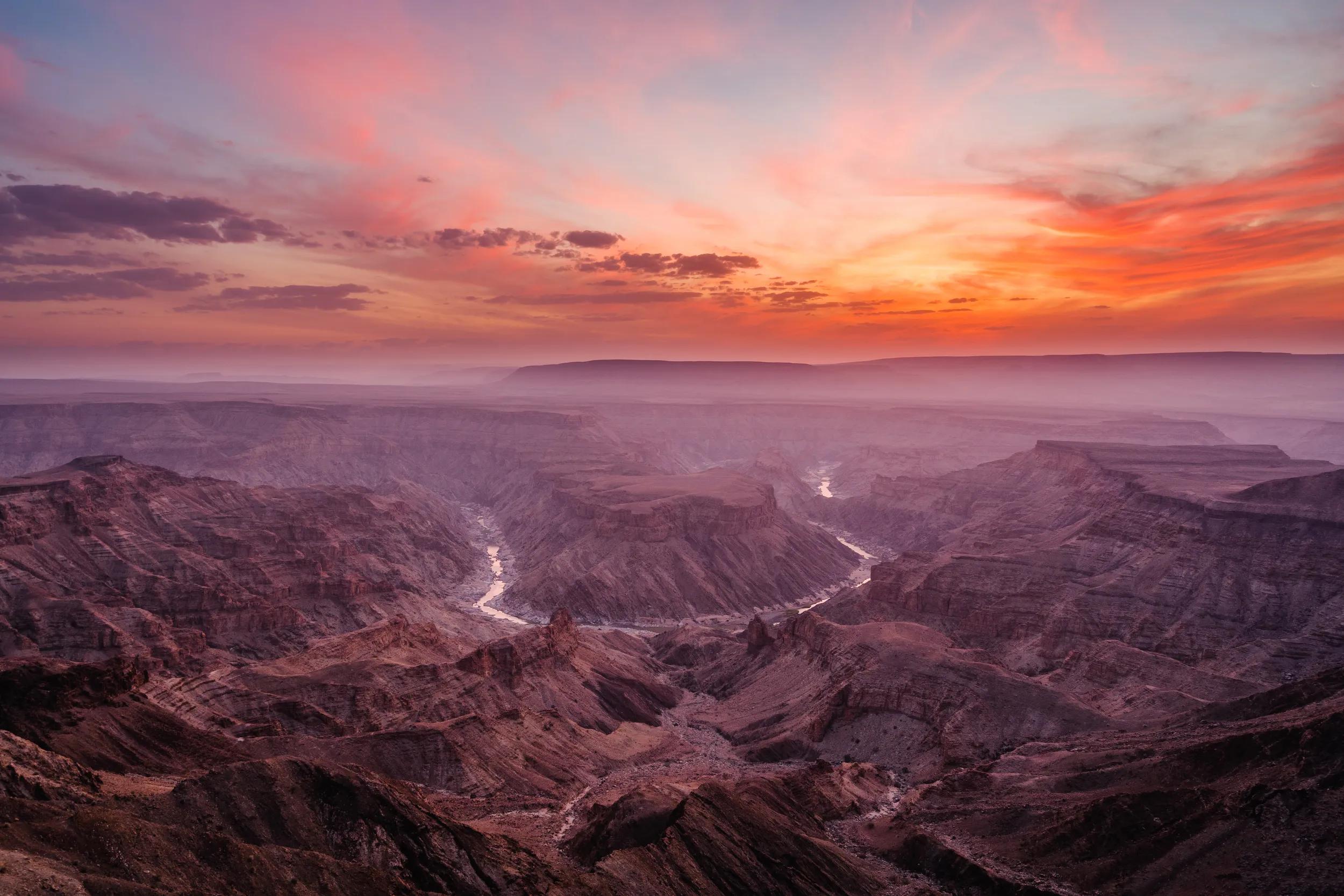 Epic sunset over the Fish River Canyon in Namibia, the second largest canyon in the world and the largest in Africa.
