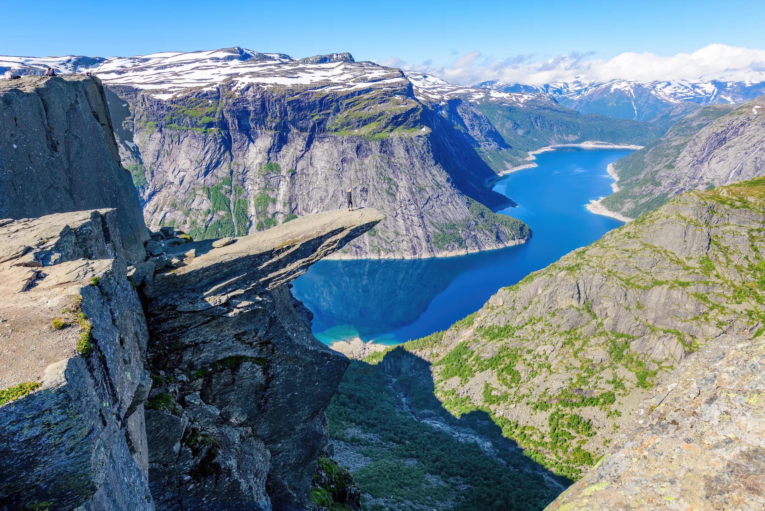 Trolltunga, Norway - July 16, 2021: Located close to the town of Odda, Tyssedal, it is a popular attraction in Norway and heavily visited  during the summer months.