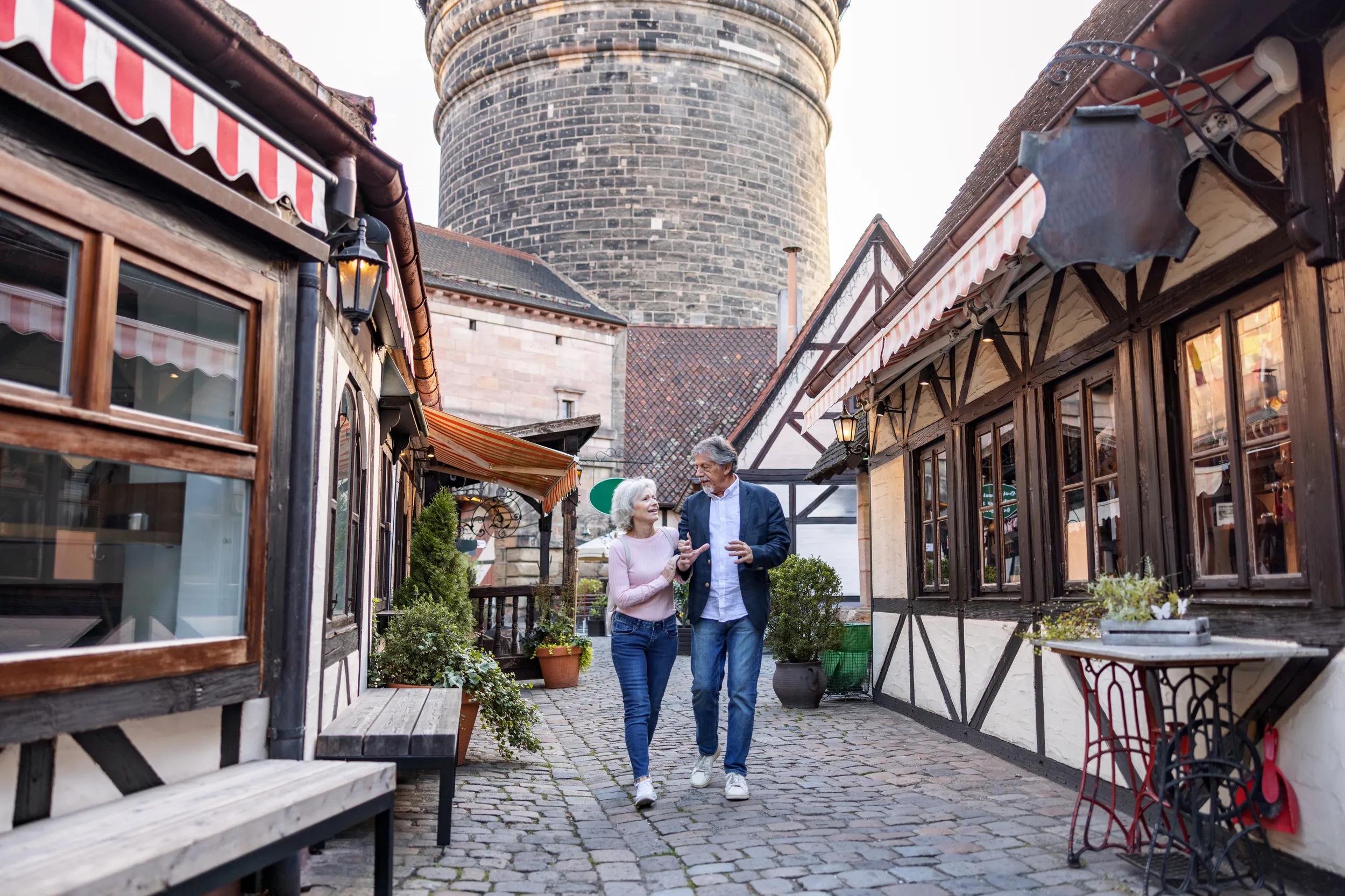 Senior Couple Exploring German Town In Summer