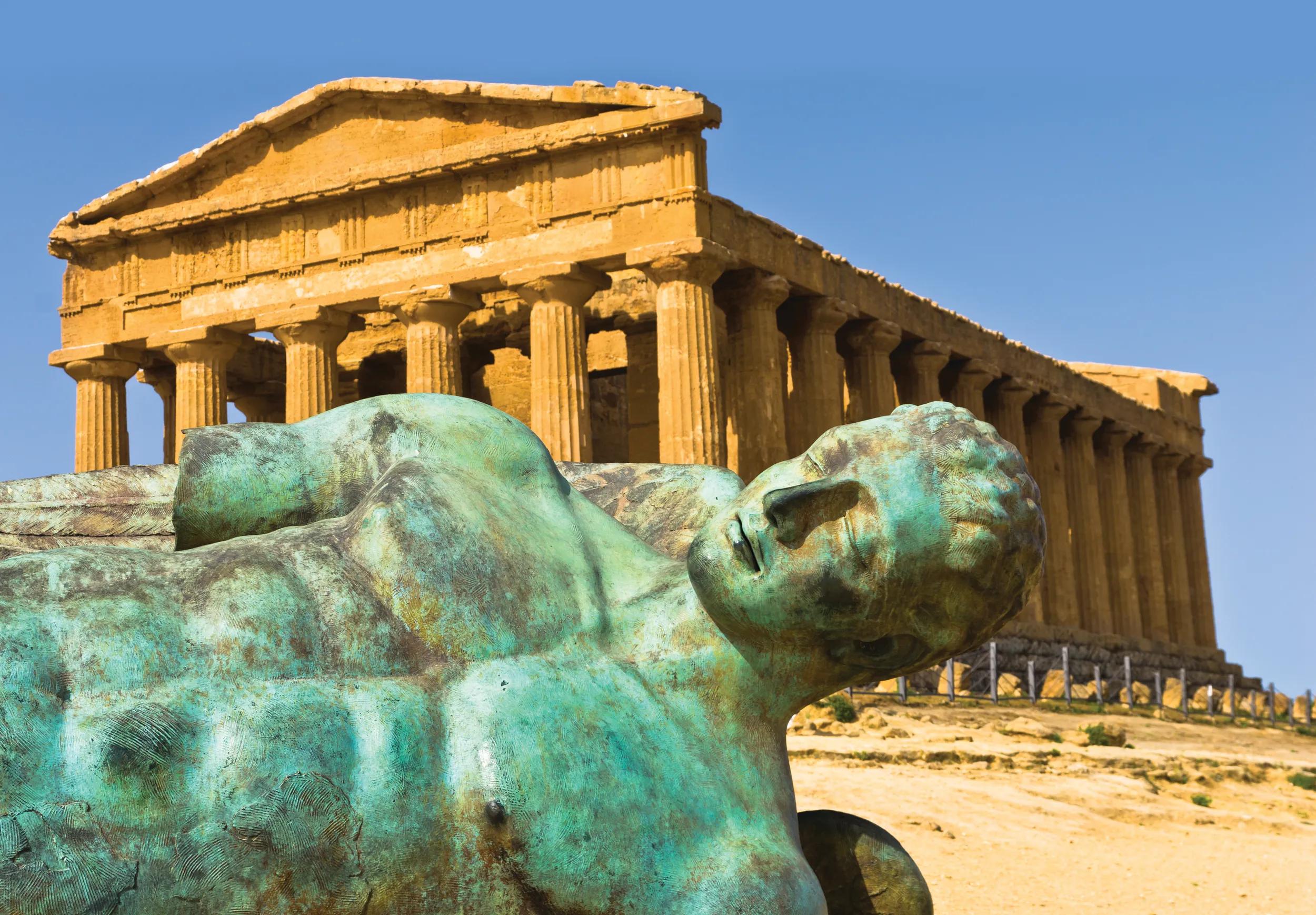 Icarus statue in front of Temple of Concordia in the Valley of Temples, an archaeological site in Agrigento, Sicily.