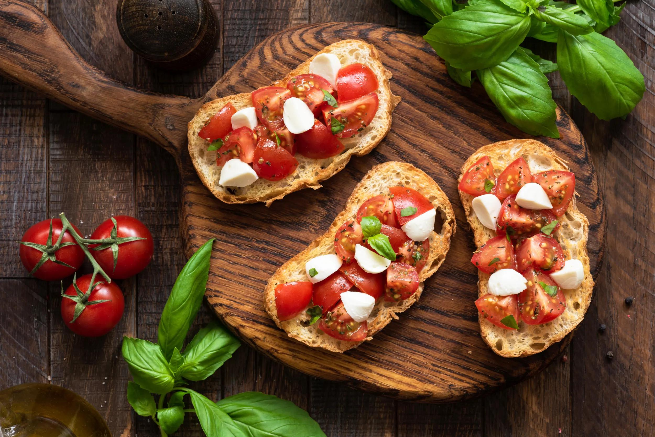 a-generic-italian-cuisine-bruschetta-with-mozzarella-cheese-1097279956-g-rf