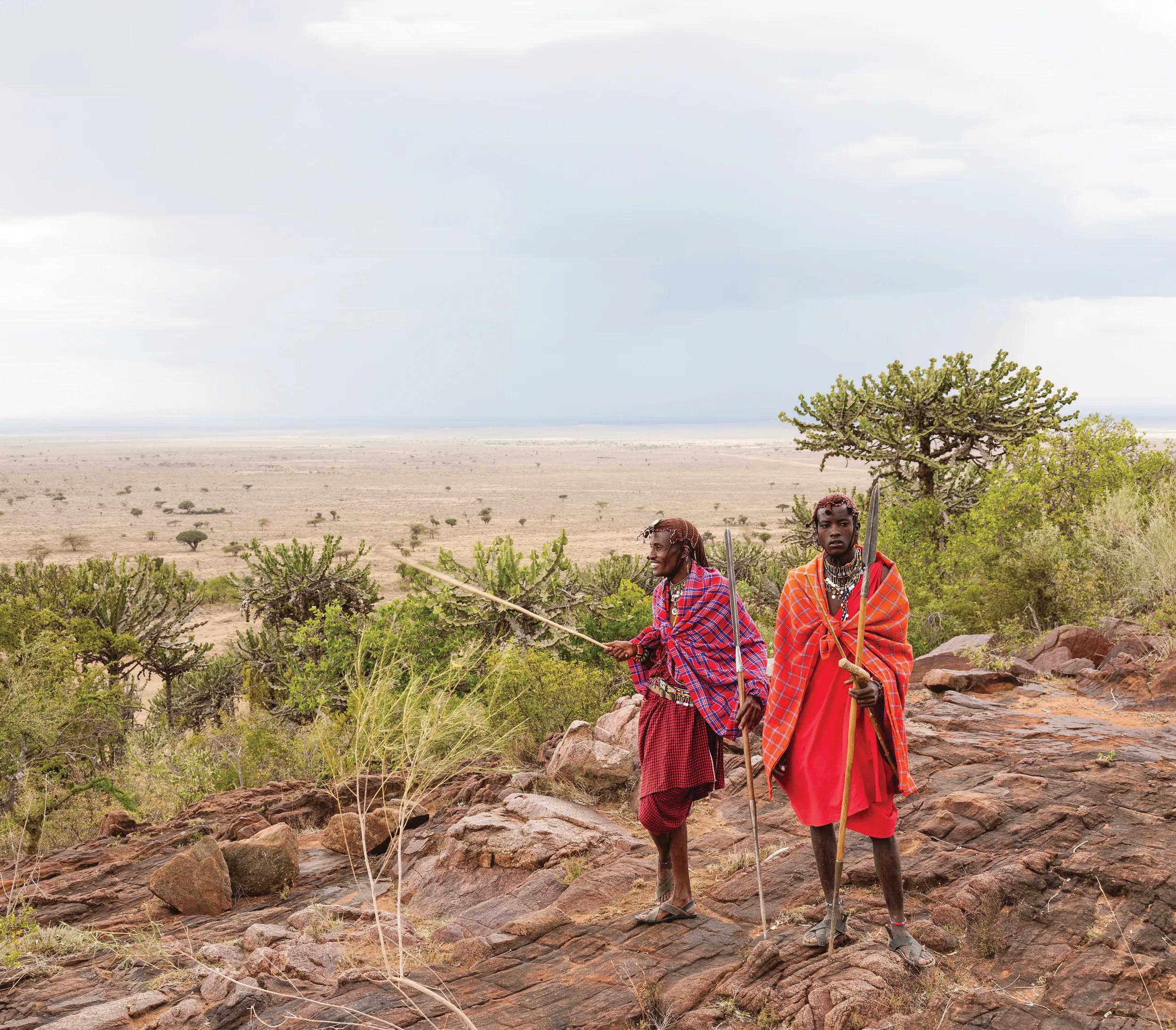 Two Masai warriors standing and looking away