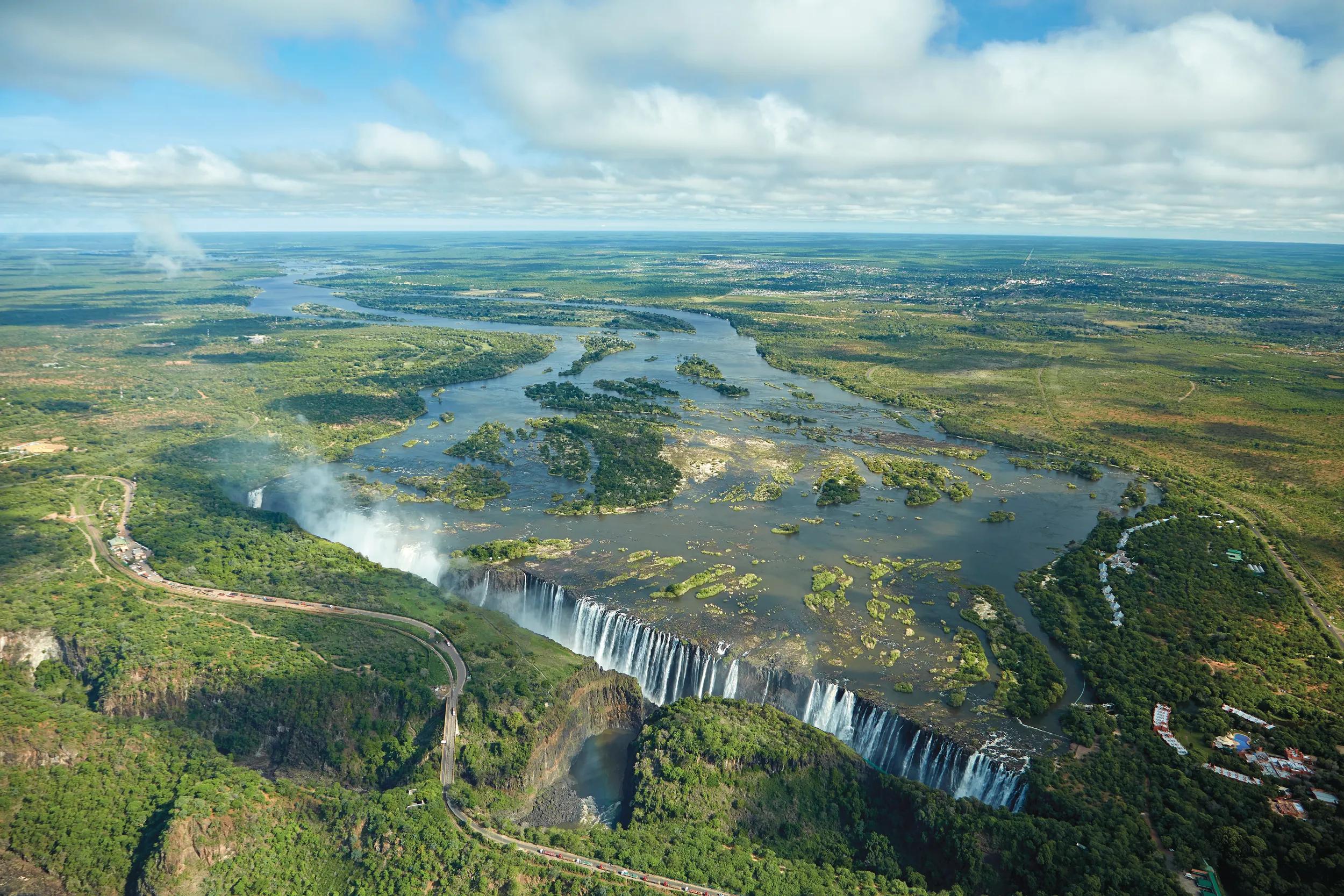 Victoria Falls or   Mosi-oa-Tunya   (The Smoke that Thunders), and Zambezi River, Zimbabwe / Zambia border, Southern Africa .