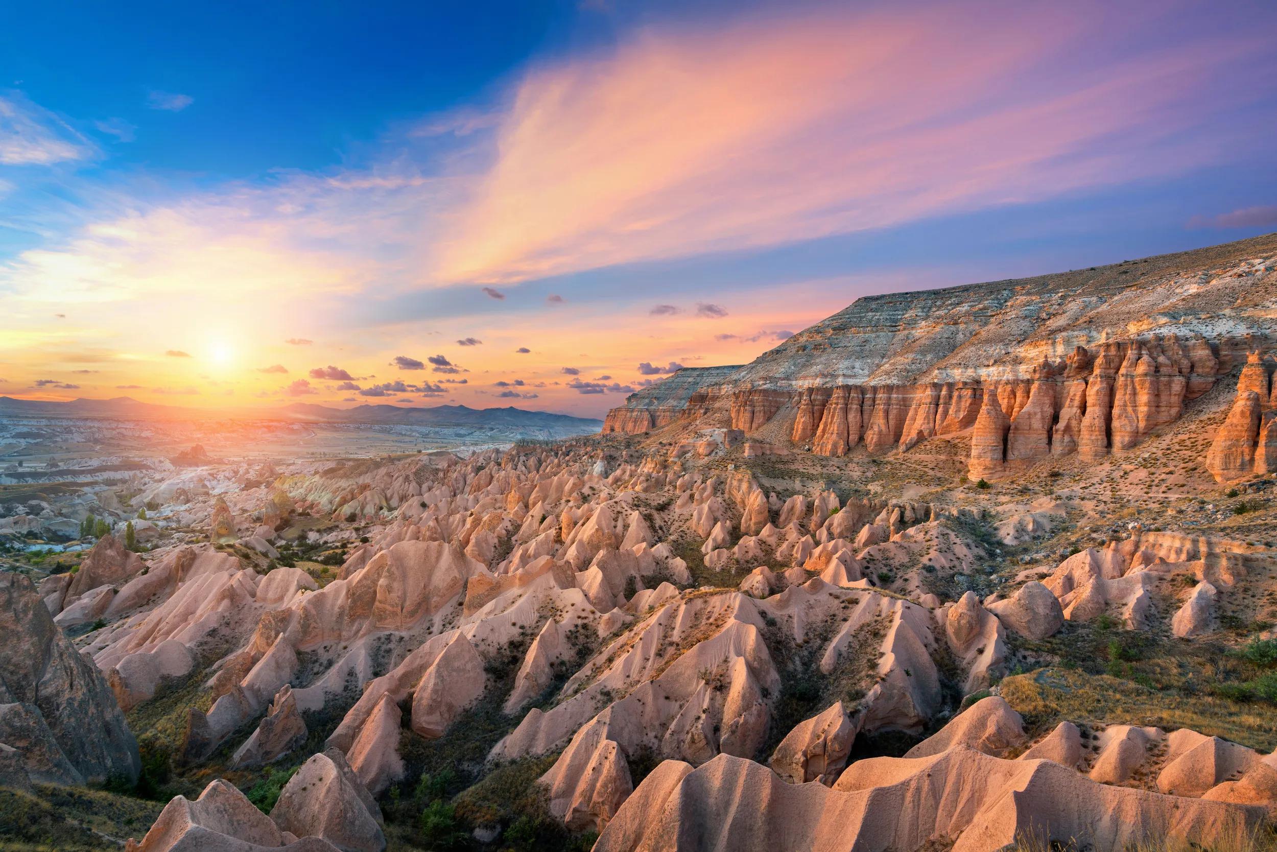 Beautiful mountains and Red valley at sunset in Goreme, Cappadocia in Turkey.