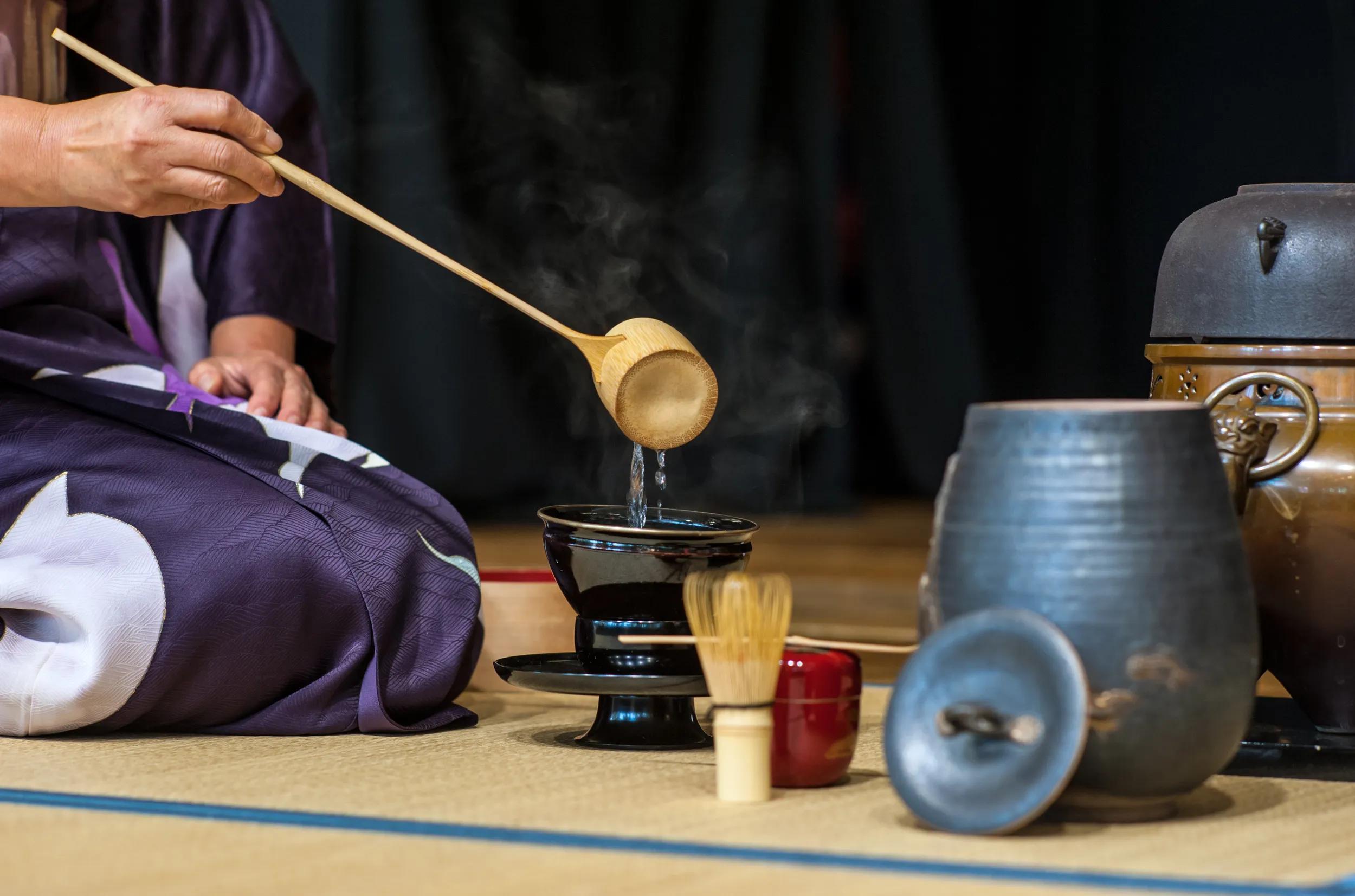 a japanese woman shows the tea ceremony during a public demonstration