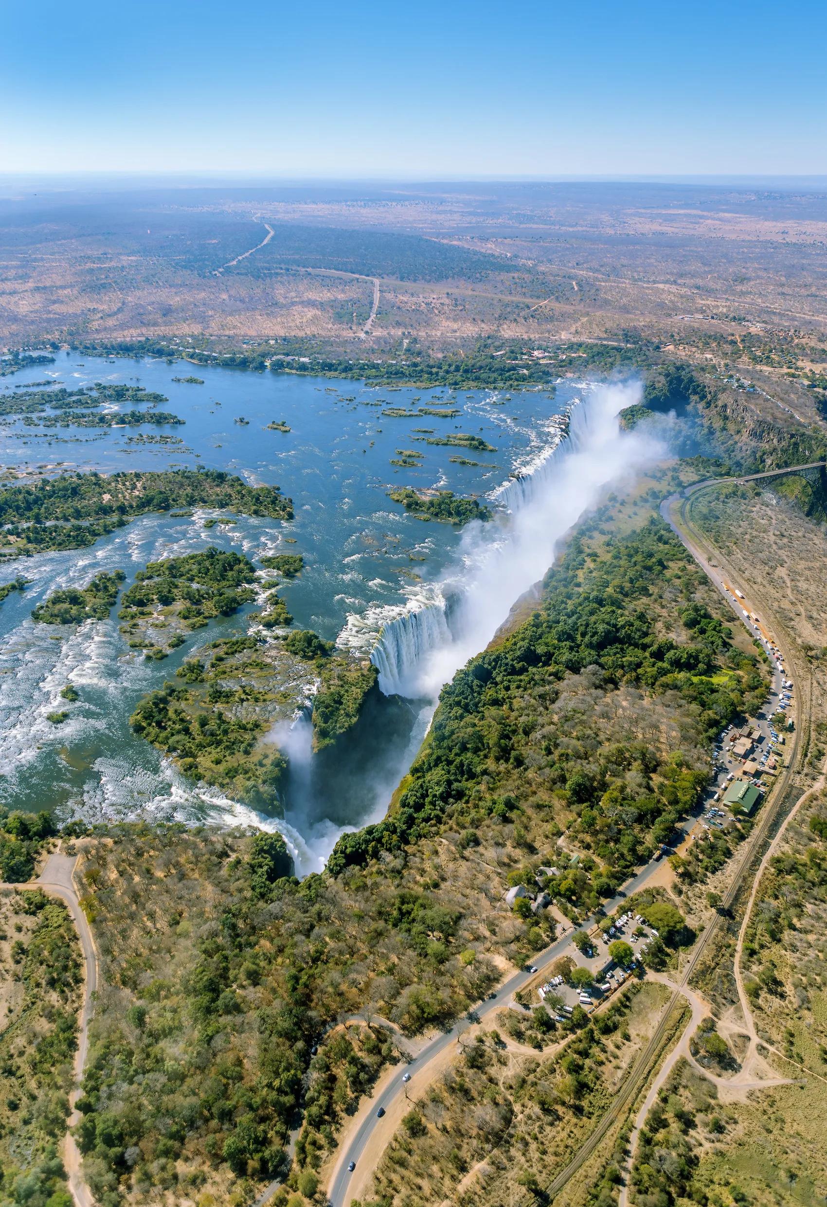 The Victoria falls is the largest curtain of water in the world (1708 m wide). The falls and the surrounding area is the National Parks and World Heritage Site (helicopter view) - Zambia, Zimbabwe