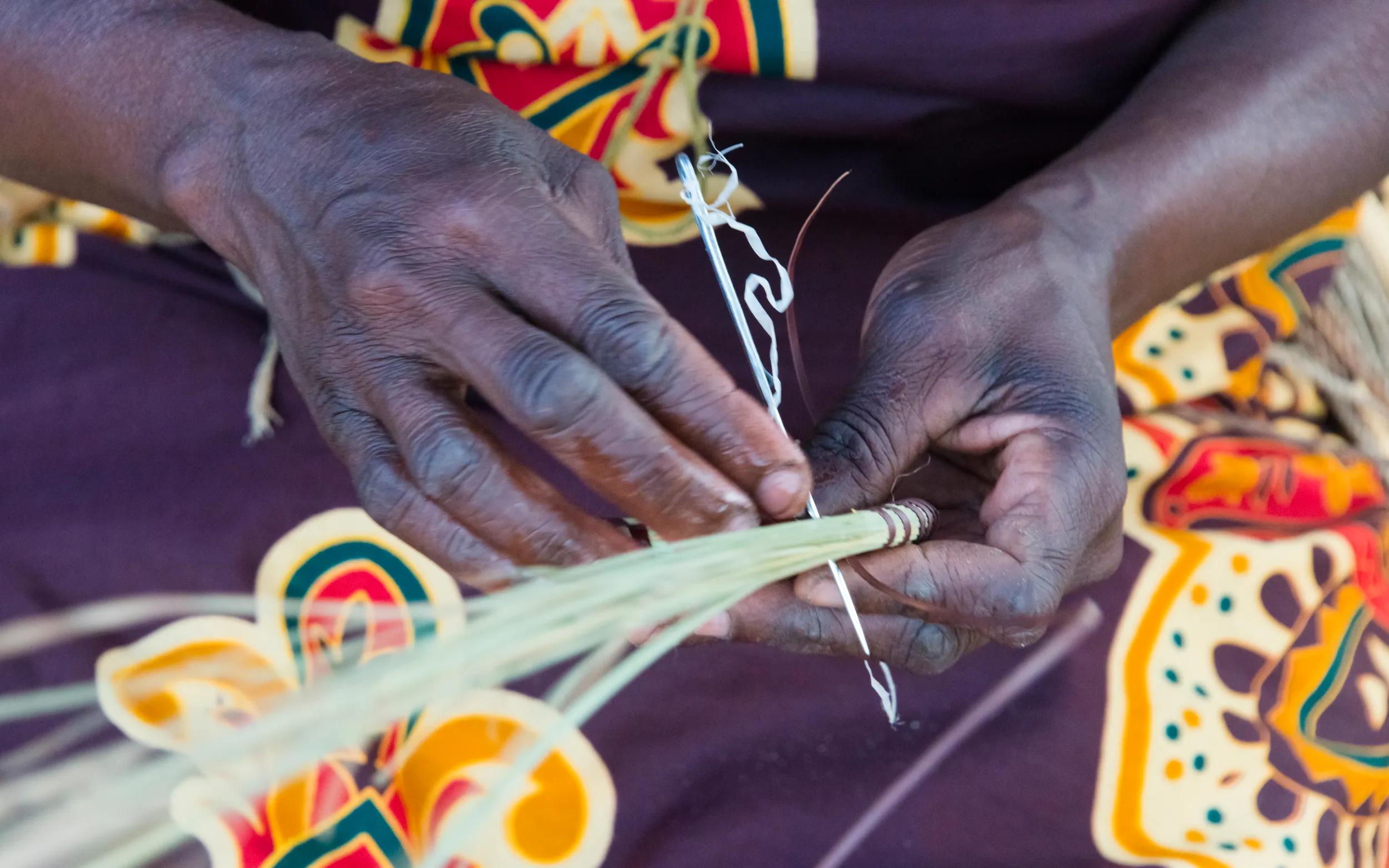 Mbukushu tribe woman weaving grass cushion, Kwando Traditional Village, Zambezi Region, Namibia